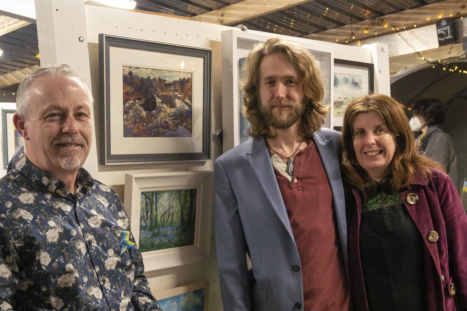 Alexander Ewen and Margaret Curran pictured with the painting they bought by Cormac Dennis (left) at the "Artist for Ukraine" exhibition at the Strand Bar Restaurant, Rush.