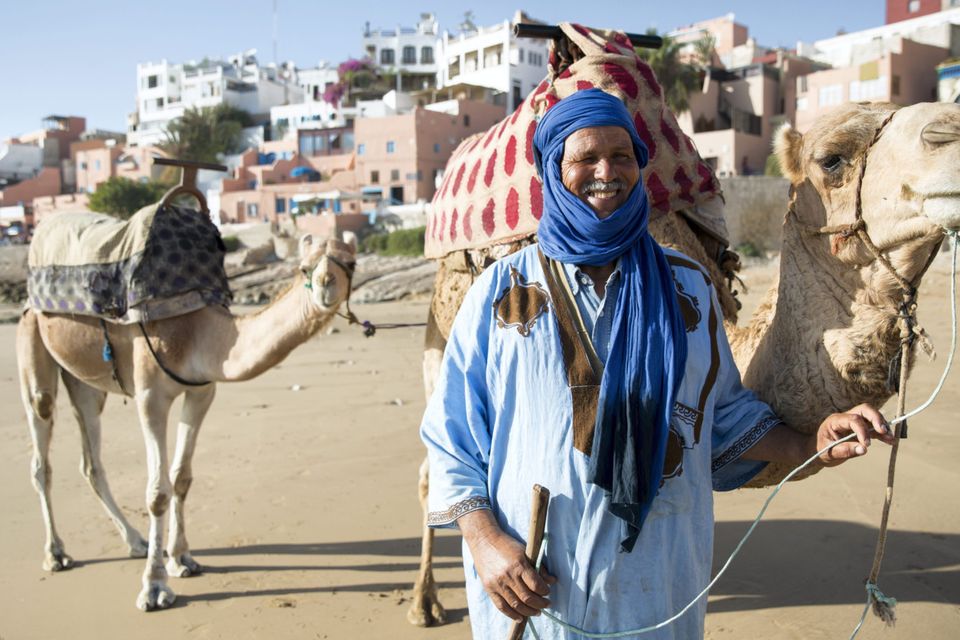 Man with camel on beach, Taghazout, Morocco