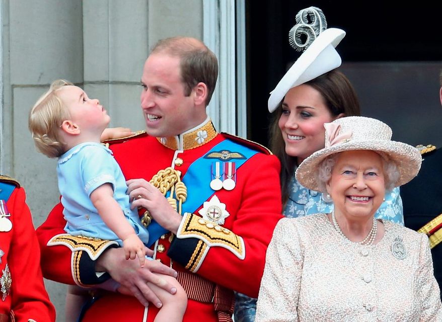 Prince George of Cambridge is held by Prince William, Duke of Cambridge and Catherine, Duchess of Cambridge, Prince Charles, Prince of Wales and Queen Elizabeth II look out on the balcony of Buckingham Palace during the Trooping the Colout