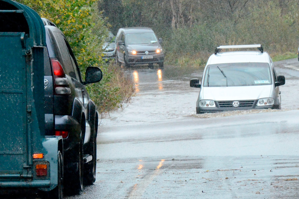 Traffic tries to navigate floods on the Castlebar to Belmullet road in Co Mayo yesterday. Picture: Paul Mealey
