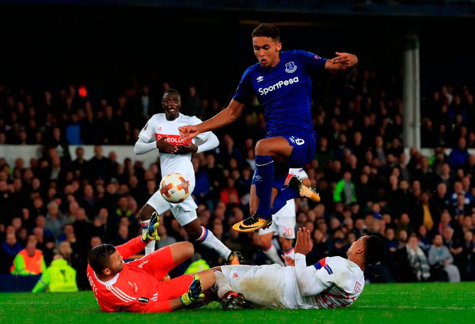 Everton's Dominic Calvert-Lewin leaps over a challenge from Olympique Lyonnais goalkeeper Anthony Lopes and Kenny Tete. Photo: Peter Byrne/PA