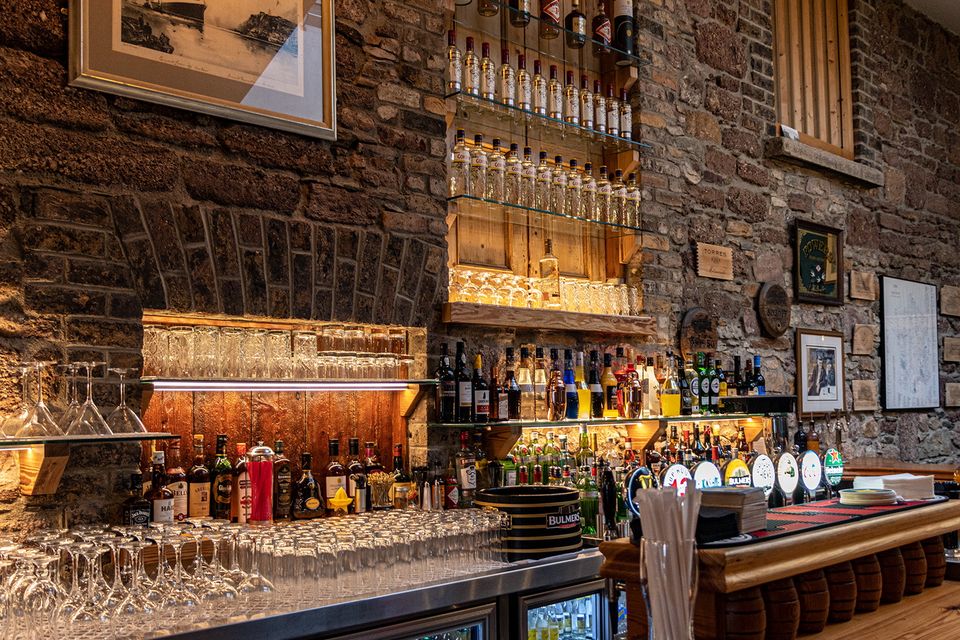 The original external stone wall which is now the backdrop to the bar.