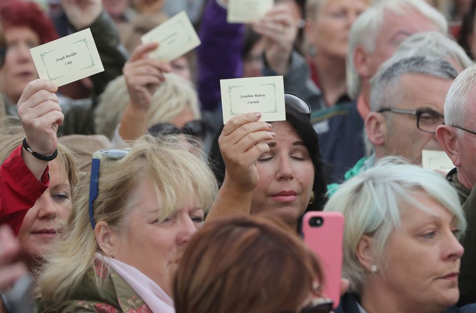 People read aloud names of children as they gather at Tuam (Niall Carson/PA)