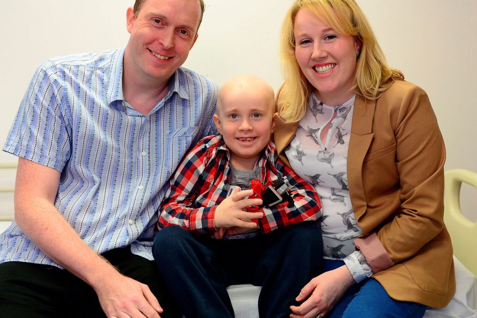 Daniel is pictured with his parents Brian and Caroline