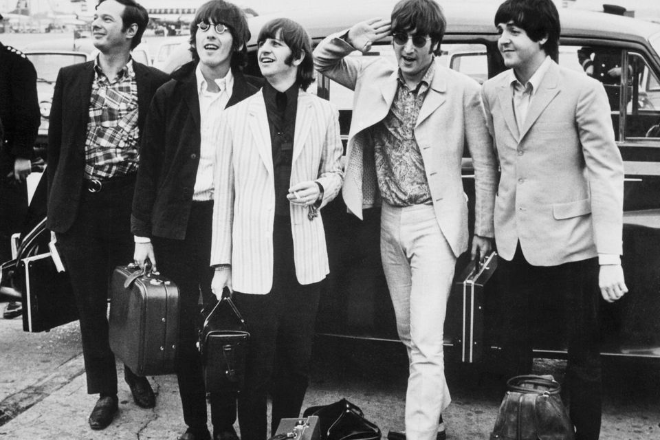 The Beatles with their manager, Brian Epstein, arriving in London where they were welcomed by a crowd of fans. Photo: Bettmann Archive