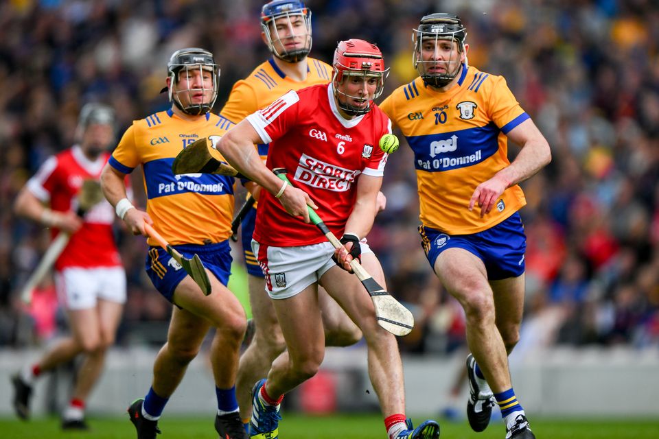 Cork's Ciarán Joyce  in action against Clare's David Reidy (L), David Fitzgerald and Cathal Malone (R). Photo: David Fitzgerald/Sportsfile