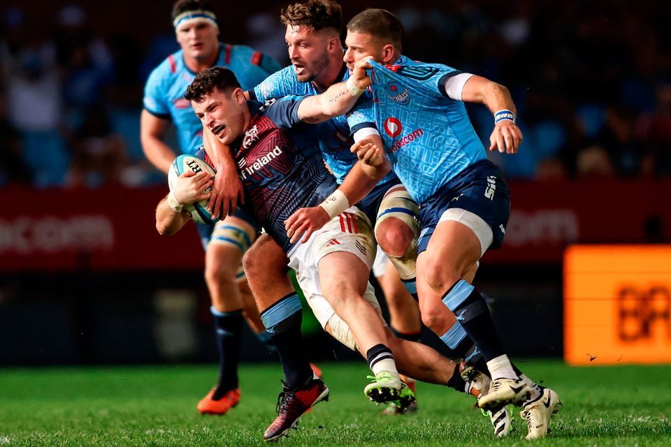 Munster's Calvin Nash is tackled by Ruan Vermaak and Willie le Roux of Vodacom Bulls during his side's  URC win. Photo: Shaun Roy/Sportsfile