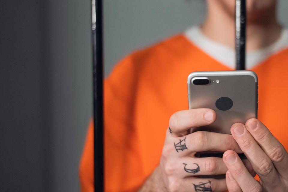 A prisoner using a mobile phone. Photo: Getty