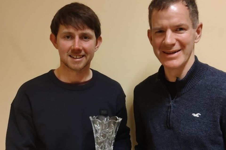 Tim Grummell presents the most improved athlete award to Robin Mooney a the Slí Cualann awards night.