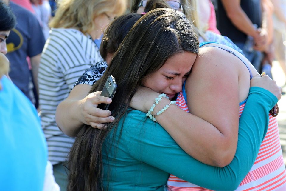 A woman is comforted after a shooting at Umpqua Community College (AP)
