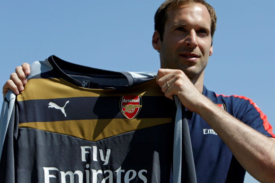 Czech soccer player Petr Cech shows his Arsenal jersey during his presentation in Prague