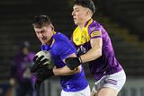 thumbnail: Wexford's Brian Molloy puts pressure on Wicklow's J.P. Hurley.