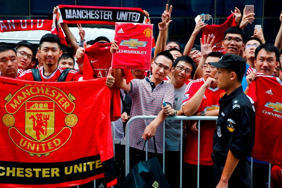 Manchester United fans at the team hotel after the match was called off with Manchester City