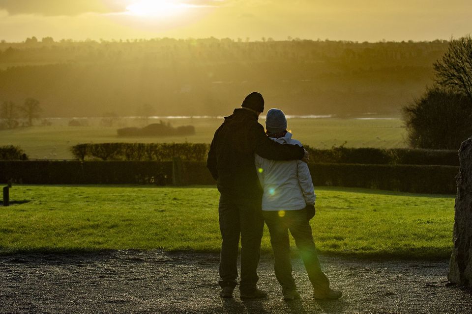 Light fantastic: A couple watch the sun break through the clouds at Newgrange in Co Meath.
Photos: Ciara Wilkinson