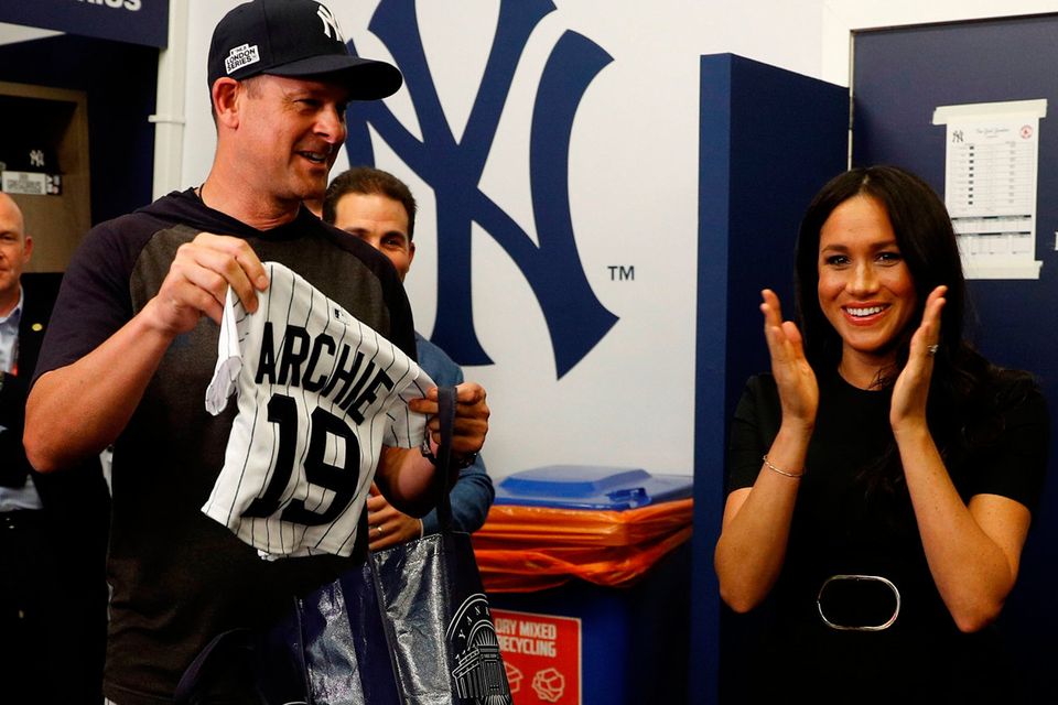 The Duke and Duchess of Sussex receive presents for their son Archie as they meet players of the New York Yankees as they  attend the Boston Red Sox vs New York Yankees baseball game at the London Stadium in support of the Invictus Games Foundation