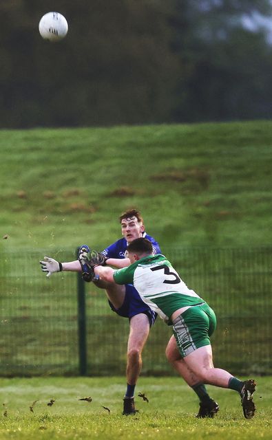 Ryan McConnell of St. Pat's gets his shot away as Tadgh O'Toole of Baltinglass closes in. 
