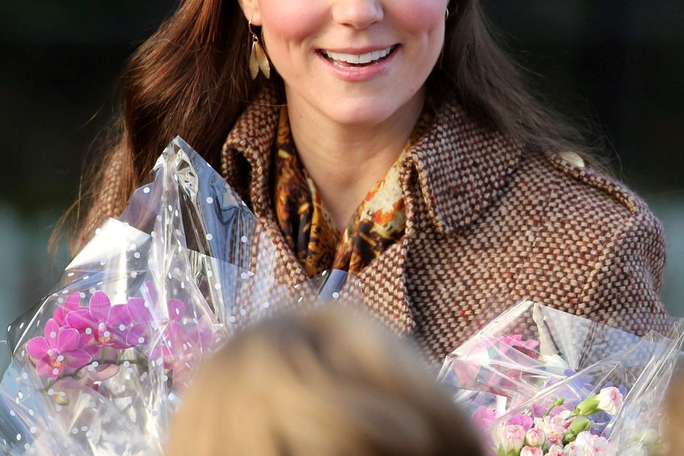 Kate Middleton receives flowers as she leaves St Mary Magdalene Church on the Sandringham estate in Norfolk following the traditional Christmas Day service. Chris Radburn/PA Wire