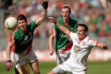 thumbnail: Mark Donnelly, Tyrone, in action against Enda Varley and Keith Higgins, Mayo.