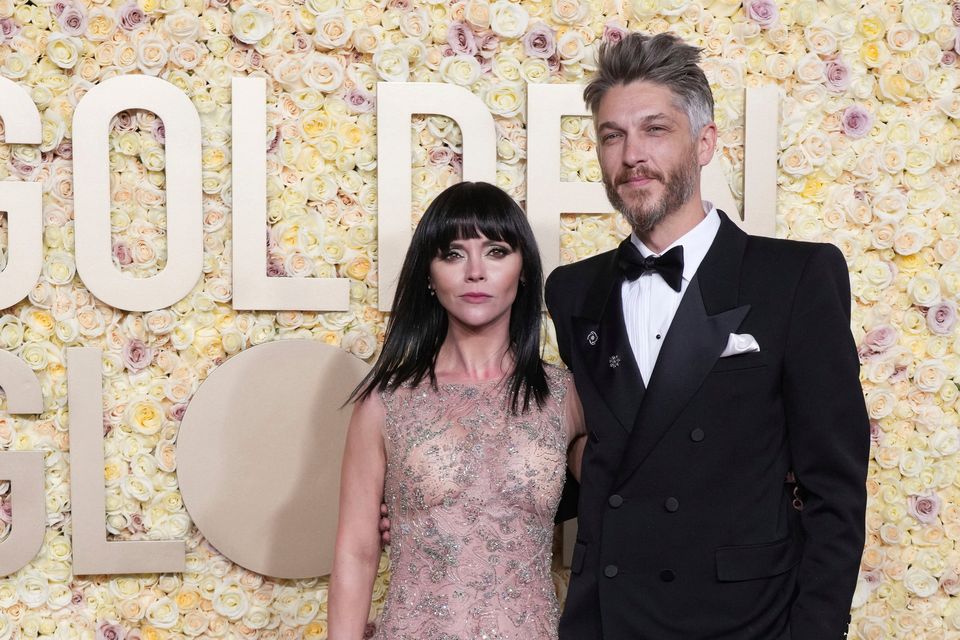 Christina Ricci, left, and Mark Hampton arrive at the 81st Golden Globe Awards on Sunday, Jan. 7, 2024, at the Beverly Hilton in Beverly Hills, Calif. (Photo by Jordan Strauss/Invision/AP)