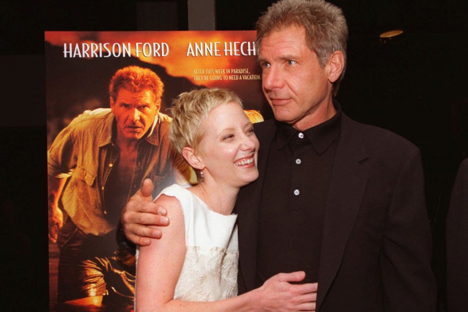 FILE - Anne Heche, left, and Harrison Ford embrace at the premiere of their film, "Six Days, Seven Nights" in the Westwood section of Los Angeles on June 8, 1998. Heche, who first came to prominence on the NBC soap opera â€œAnother Worldâ€ in the late 1980s before becoming one of the hottest stars in Hollywood in the late 1990s, died Sunday, Aug. 14, 2022, nine days after she was injured in a fiery car crash. She was 53. (AP Photo/Chris Pizzello, File)