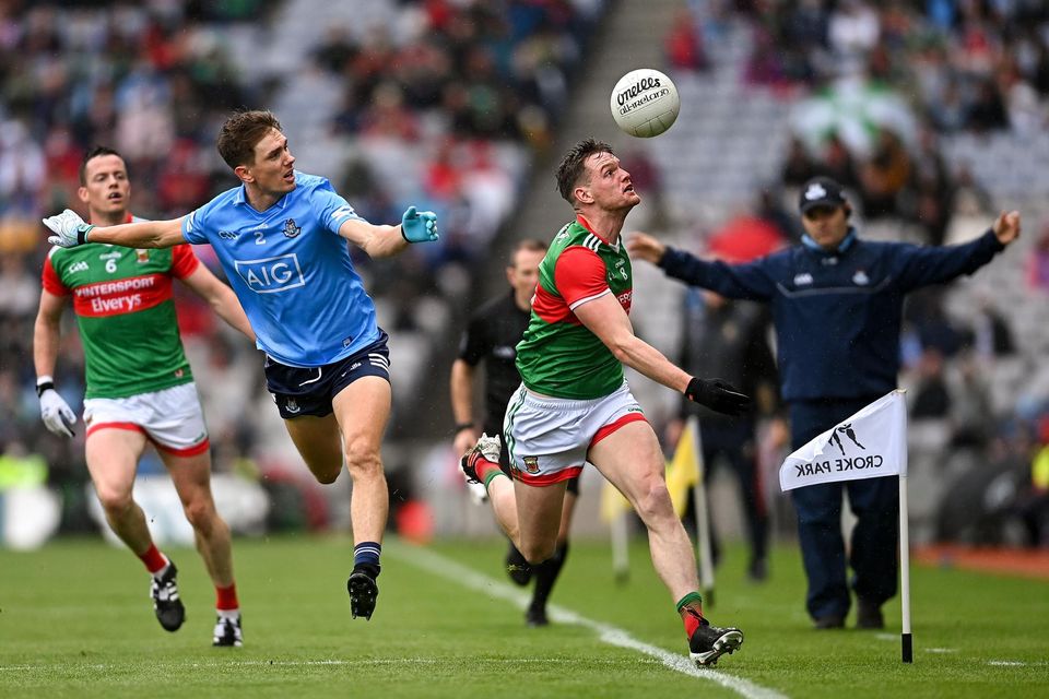 Mayo's Matthew Ruane tries to keep the ball in play ahead of Dublin's Michael Fitzsimons during the 2021 All-Ireland SFC semi-final at Croke Park. Photo: Ramsey Cardy/Sportsfile