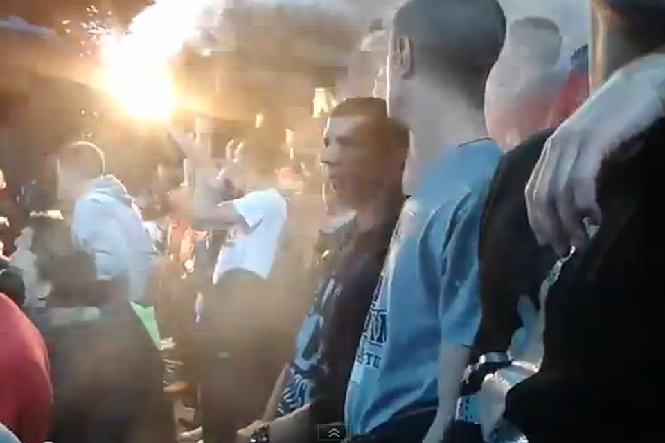 A fan holds the flare which hit Igor Akinfeev