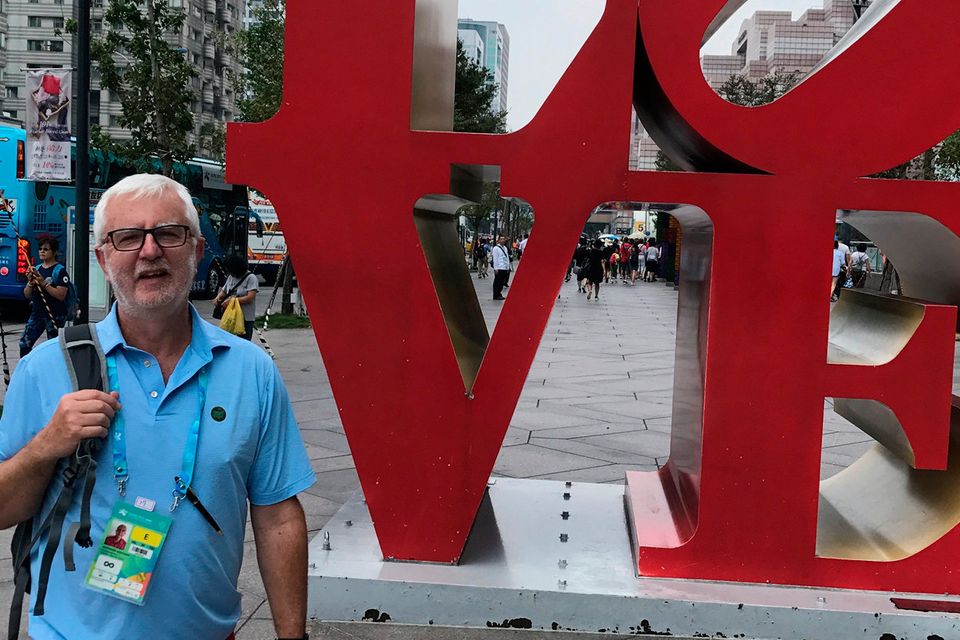 Beatles fan John simply couldn't resist having a photo with giant LOVE sculpture