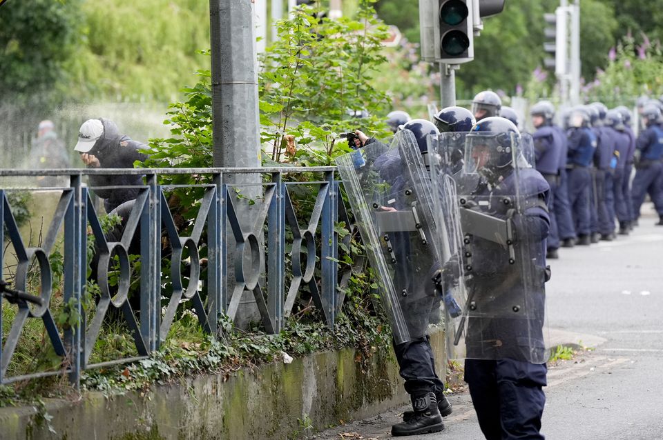 Gardai public order unit officers deploying pepper spray at protesters at the former site of the Crown Paints factory in Coolock, north Dublin, last July. Photo: Niall Carson/PA