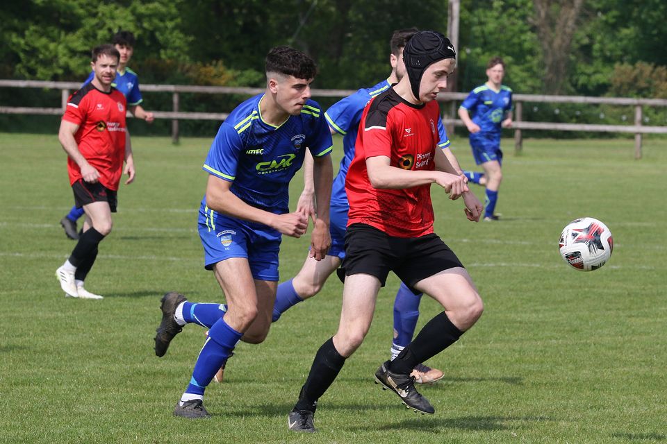 Damien Duke of Bunclody is chased by Cillian Thomas (New Ross Town). Photo: John Walsh