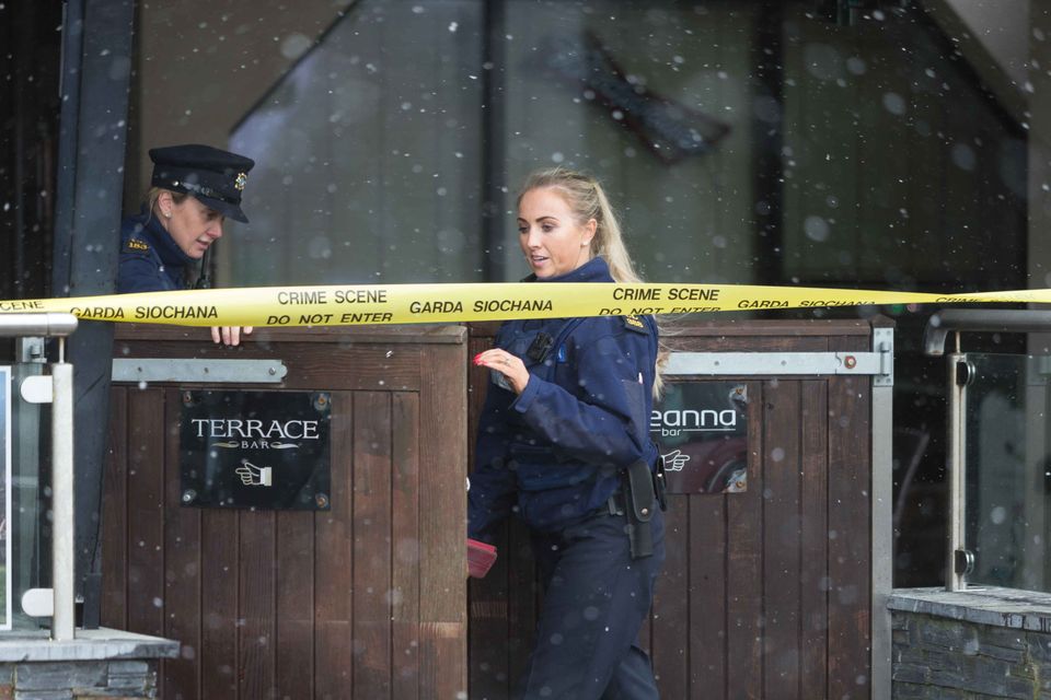 Gardai examine the crime scene outside the Shannon Knights club