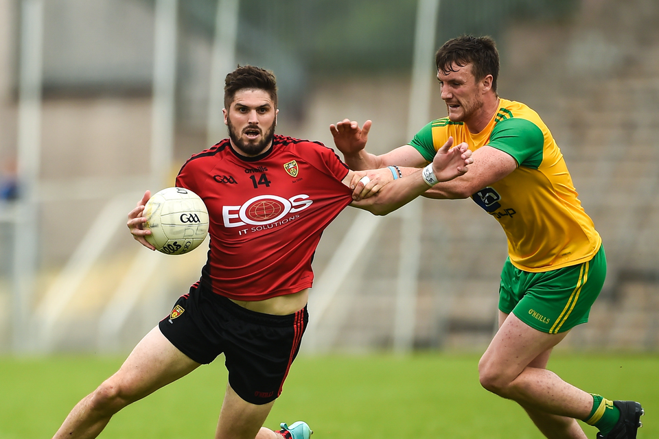 Connaire Harrison of Down  in action against Leo McLoone of Donegal during the Ulster GAA Football Senior Championship Semi-Final match between Donegal and Down at St Tiernach's Park in Clones, Monaghan.