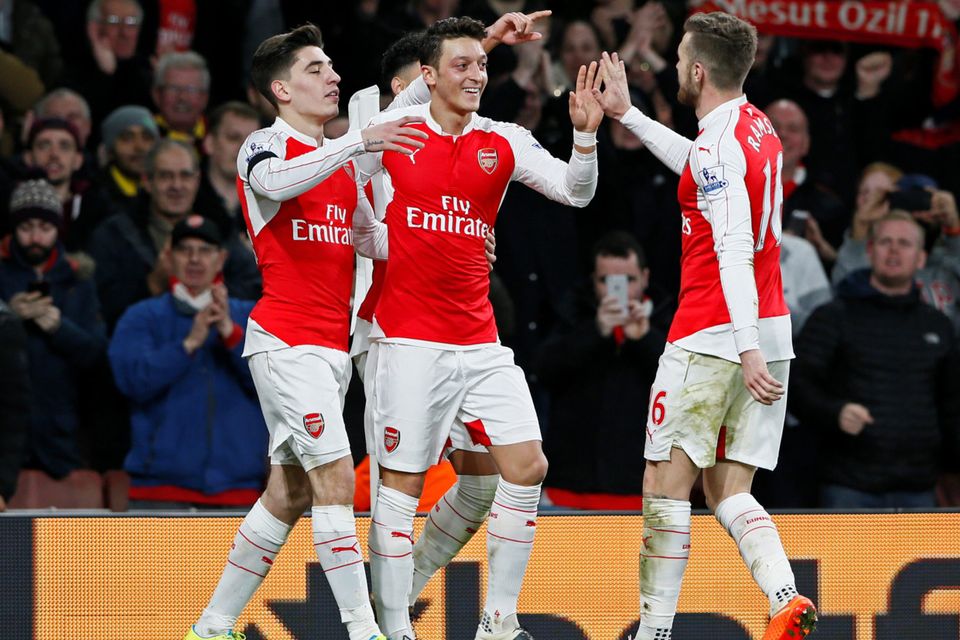 Arsenal’s Mesut Ozil celebrates scoring their second goal with Hector Bellerin and Aaron Ramsey
