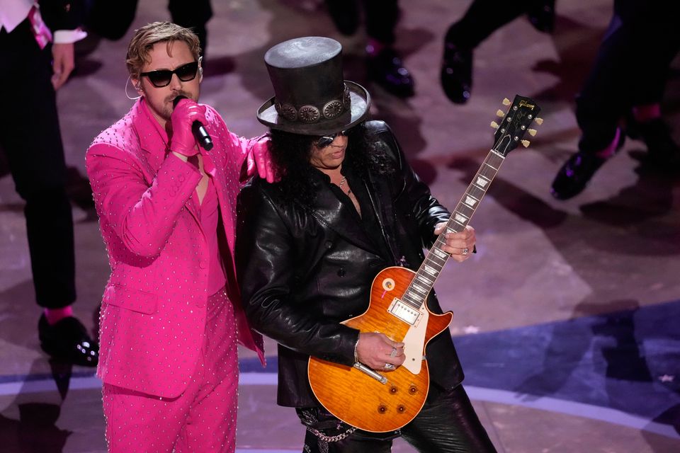Ryan Gosling performs "I'm Just Ken" from the movie "Barbie" with Slash, right, playing the guitar during the Oscars (AP Photo/Chris Pizzello)