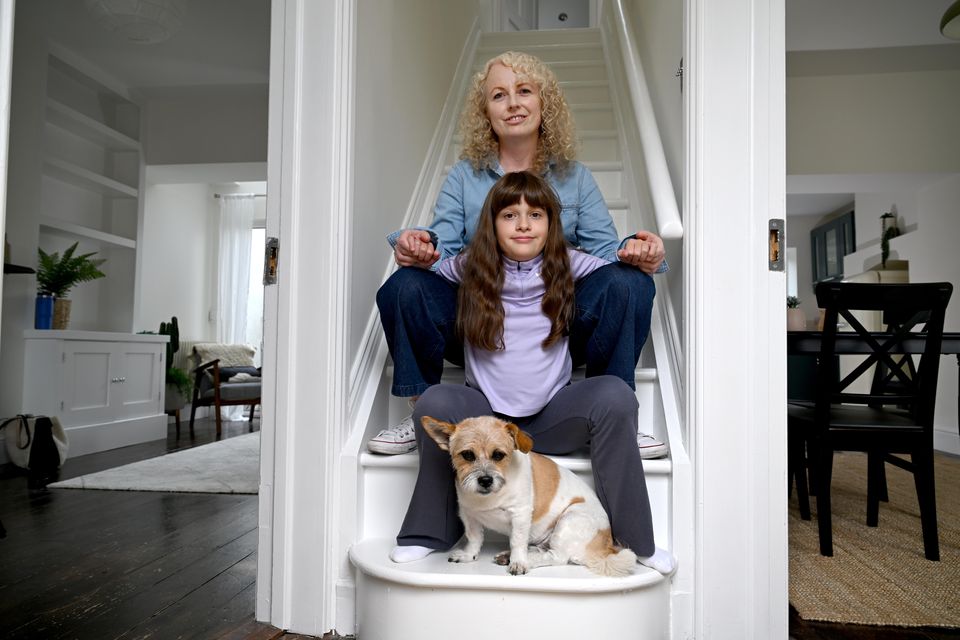 Fiona Egan and daughter Grace with Molly the dog at the D8 railway cottage. Photo: Bryan Meade