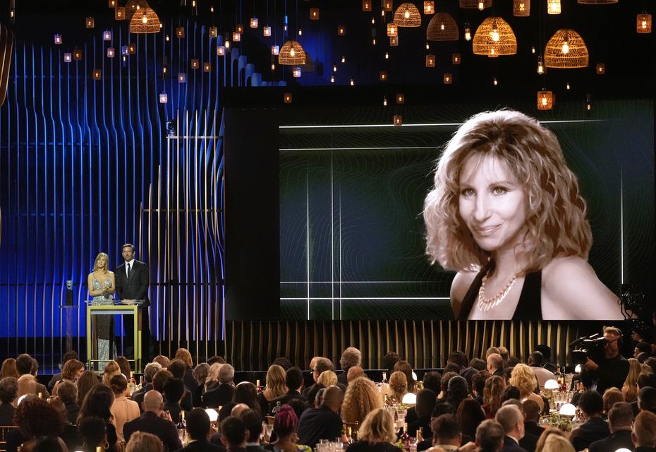 Jennifer Aniston, left, and Bradley Cooper present the lifetime achievement award to Streisand during the 30th annual Screen Actors Guild Awards (AP Photo/Chris Pizzello)