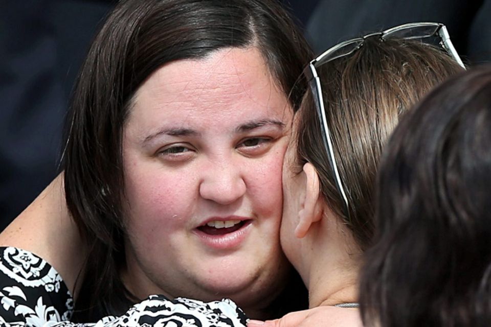 Sinead, daughter of Laurence and Martina Hayes, is consoled at their funeral