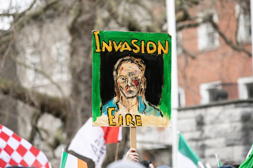 A placard is displayed during a march by anti-immigration protesters in Dublin city centre on Monday. Photo: Collins