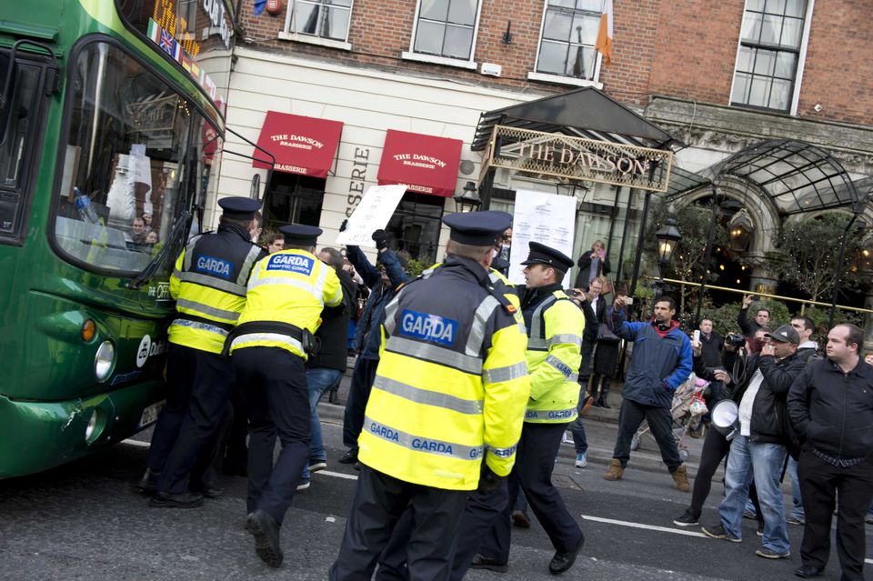 Protesters are confronted by gardai outside the Mansion House in Dublin yesterday. Photo: El Keegan