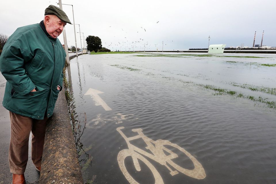 Billy Bradshaw looks at flooded cycle lanes in Clontarf, Dublin. Picture: Steve Humphreys