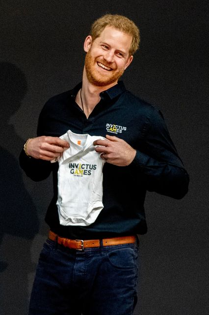 Prince Harry, Duke of Sussex is presented with an Invictus Games baby grow for his newborn son Archie by Princess Margriet of The Netherlands during the launch of the Invictus Games on May 9, 2019 in The Hague, Netherlands. (Photo by Patrick van Katwijk/Getty Images)