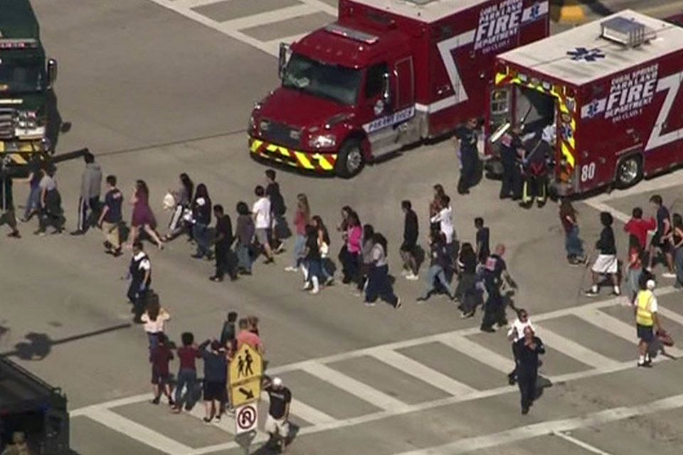 Students are evacuated from Marjory Stoneman Douglas High School during a shooting incident in Parkland, Florida, U.S. February 14, 2018 in a still image from video.  WSVN.com via REUTERS