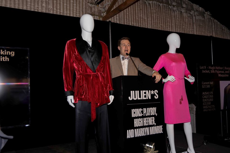 Auctioneer Kody Frederick presented Hugh Hefner’s smoking jacket and Marilyn Monroe’s pink Pucci dress at the sale in Los Angeles (Julien’s Auctions/PA)