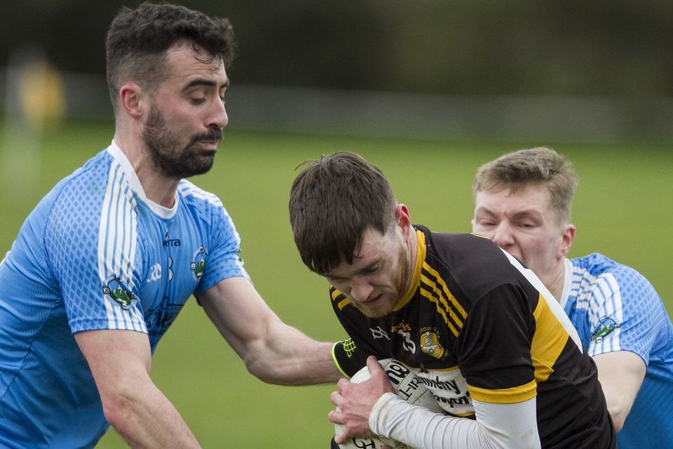 Currow corner forward, Jack Moriarty holds possession in spite of the pressure from Firies midfielder Jack Sherwood (left) and corner back Brian O'Leary in their Credit Union County League Division 2 Round 1 game in Currow on Sunday. Photo by John Reidy
