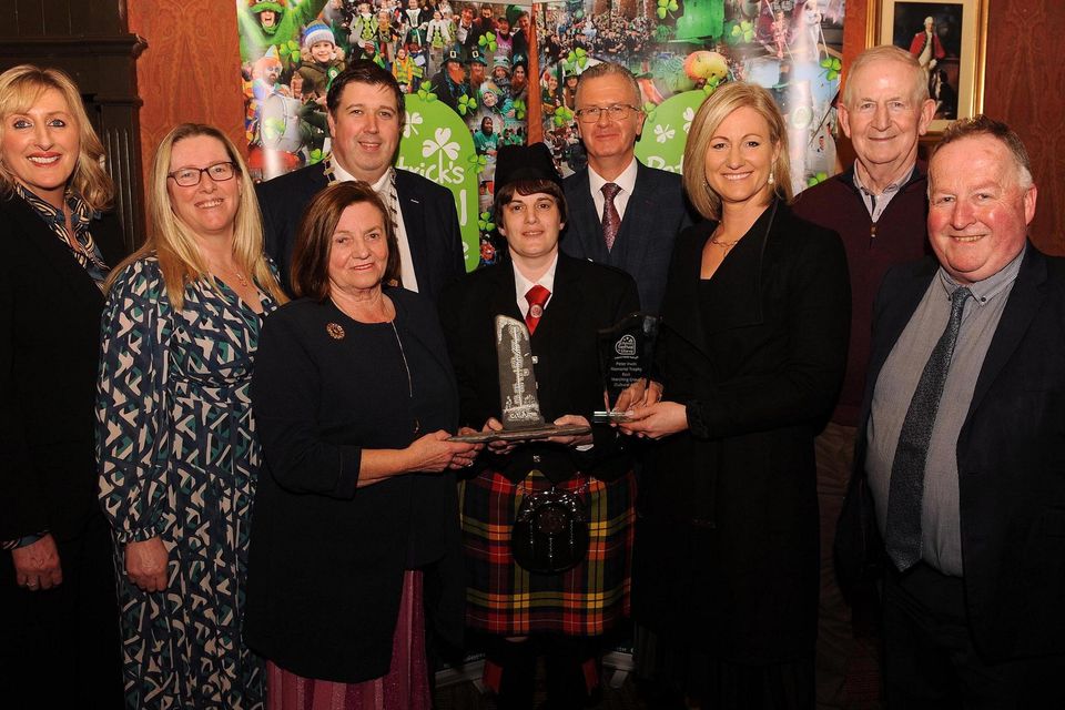Teresa Irwin presents the The Peter Irwin Memorial Perpetual Award for Best Marching Group/Cultural Arts to Gillian McCarthy, Millstreet Pipe Band. Also included are Bridget O'Keeffe (Killarney Chamber of Tourism and Commerce Senior Executive), Ciara Irwin Foley, Cllr Niall Kelleher, Mayor of Killarney, and PJ McGee, Daly's SuperValu, sponsor, Emir Irwin O'Shea, Cathal Walshe, Grand Marshal, and St. Patrick's Festival Killarney Chairman Paul Sherry at the St. Patrick's Festival Killarney parade prizegiving function in The International Hotel on Tuesday night. Picture: Eamonn Keogh