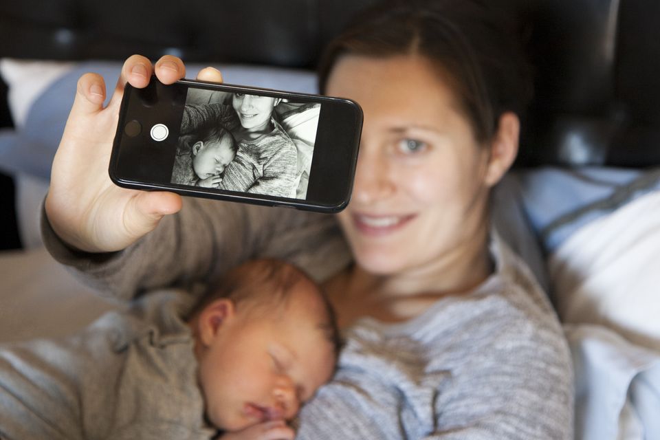 An average 973 photos are posted online by parents before their children turn five (stock image)