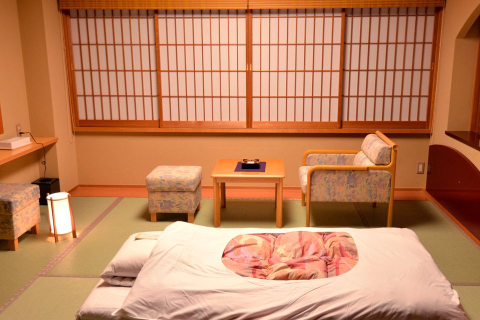 A futon is laid out for the evening at a ryokan, or traditional Japanese Inn. Omotenashi no Yado Keizankaku, outside Kyoto.
