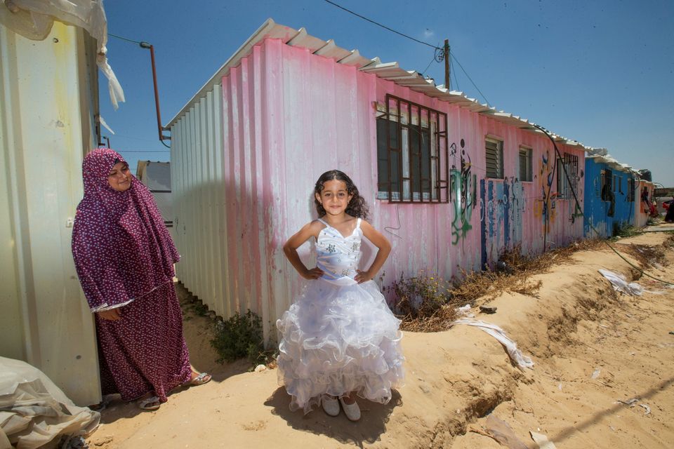 Maisoon Abu Reyda (37) and her daughter Dana (5) who live in a tin hut at a camp for families whose homes were destoryed during last summer's war in Gaza. Photo: Mark Condren