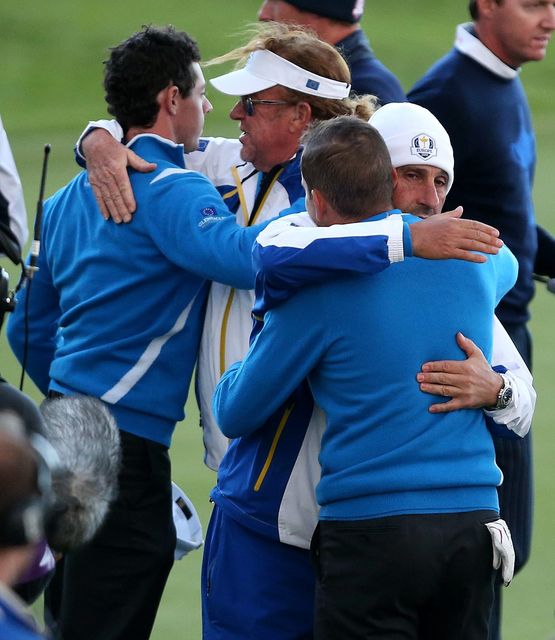 Europe's Rory McIlroy (left) is congratulated by vice captain Miguel Angel Jimenez (second left) and Sergio Garcia is congratulated by vice captain Jose Maria Olazabal (left) after their foursomes matches during day one of the 40th Ryder Cup at Gleneagles Golf Course, Perthshire