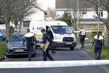 thumbnail: Gardai search near the scene at Grange View Way. Photo: Collins