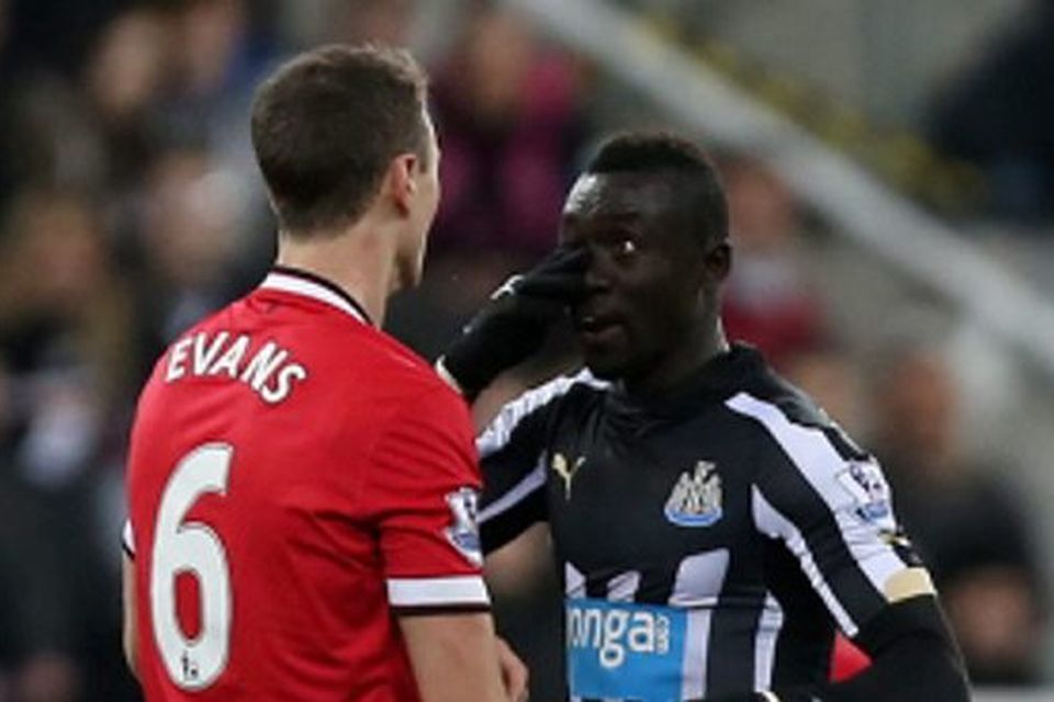 Manchester United's Jonny Evans clashes with Newcastle's Papiss Cisse